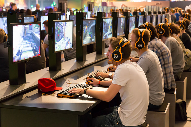 Gamers focused on screens playing Overwatch